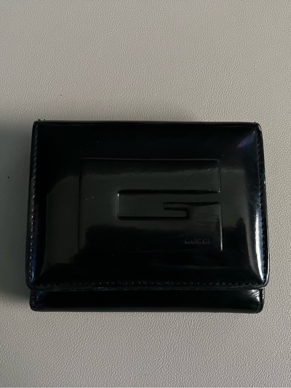 Authentic Gucci Black Patent Leather Bi-Fold Wallet with Embossed G